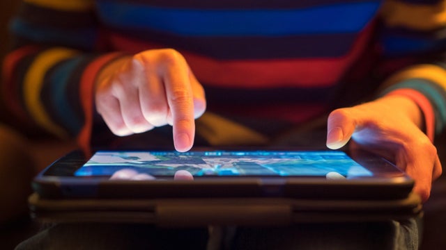 Close up of a young boy using a tablet computer 